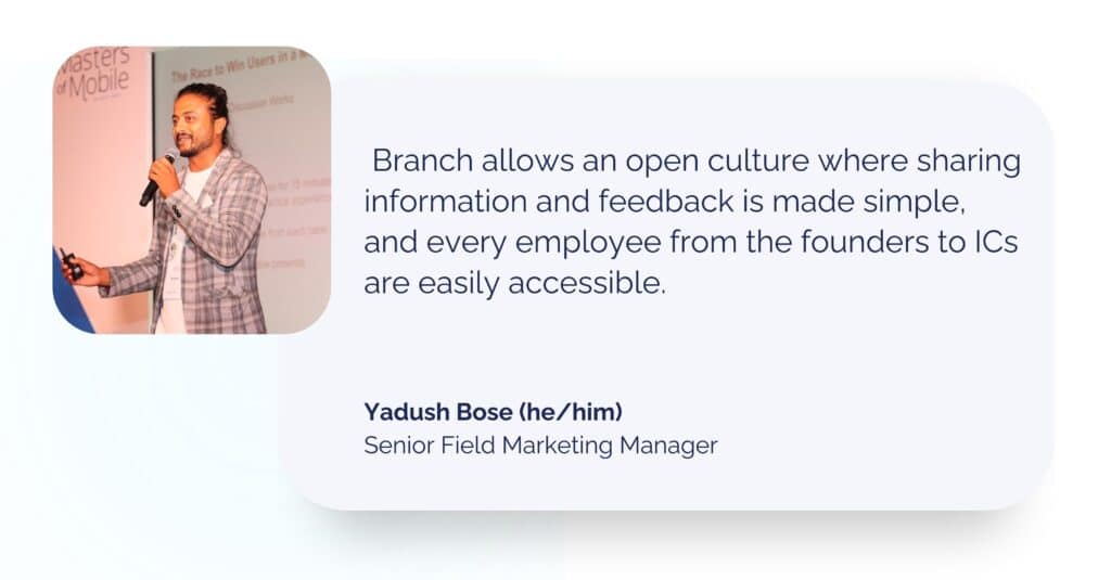 A speaker in a checked blazer shares insights on balancing work and sports in a hybrid work environment, with a presentation in the background.