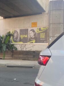 Printed billboard promoting specific content and including a QR code